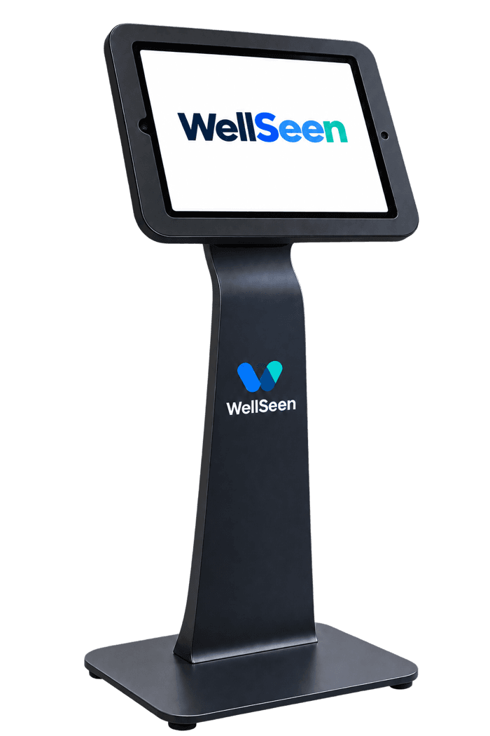 The WellSeen Classroom Kiosk: a tablet in a secure dark enclosure on a branded floor stand, its screen showing the WellSeen wordmark.